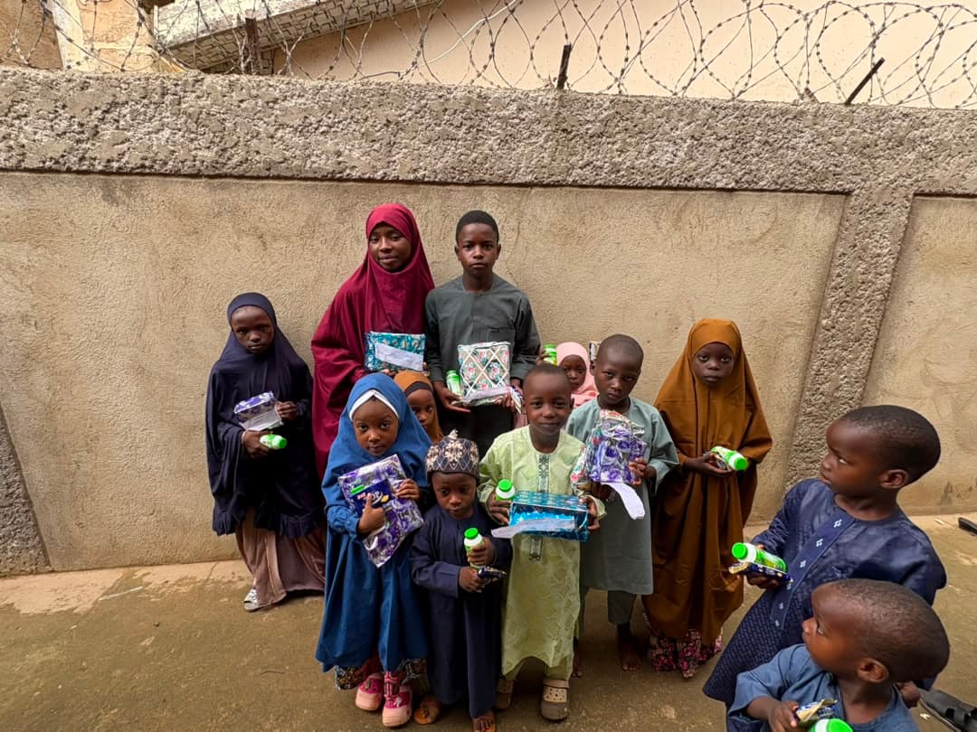 A group of children holding gift packs from Radiant Relief Foundation