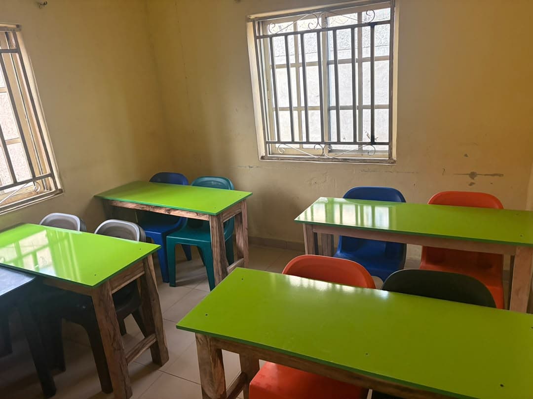 A classroom furnished by Radiant Relief Foundation, with green desks and colourful chairs